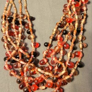 Multi beaded necklace with red,orange,pink beads that fits closer to your neck